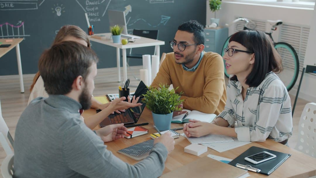 Diverse team collaborating around a table in office