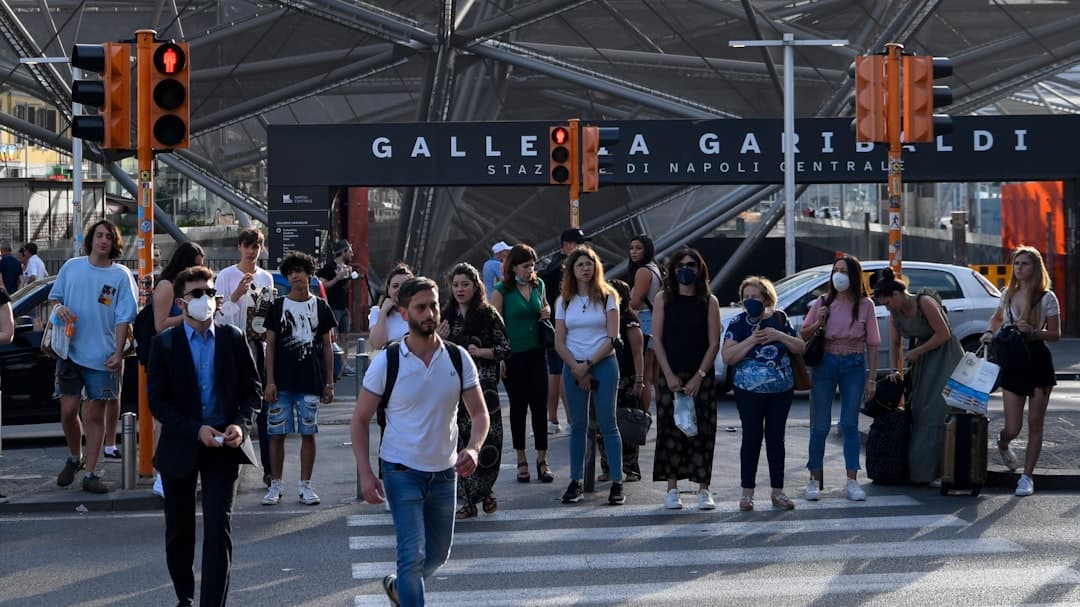 People crossing a street near galleria garibaldi station.