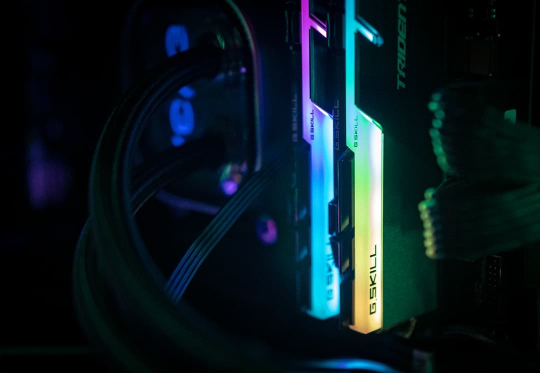 a close up of a computer and wires in a dark room