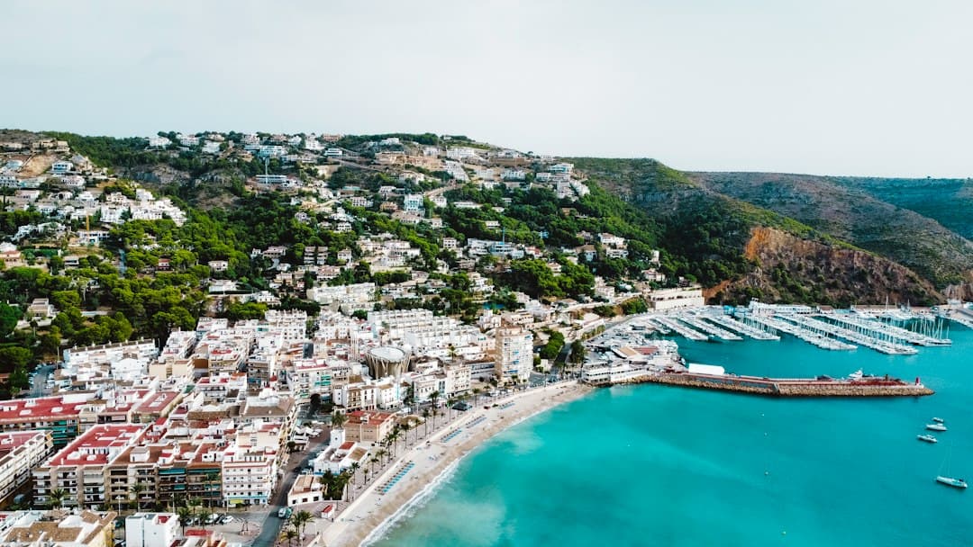 an aerial view of a city next to a body of water