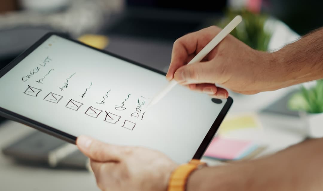Writing on a checklist with a stylus.