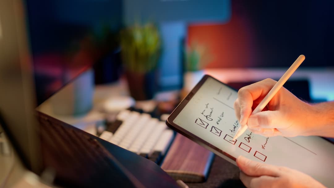 Someone is writing on a tablet with a stylus.