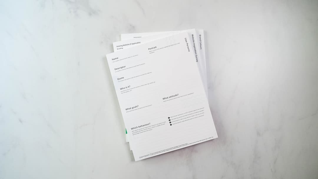 a stack of papers sitting on top of a white counter