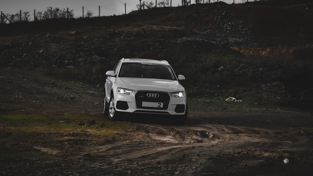 white and black bmw m 3 on dirt road during daytime