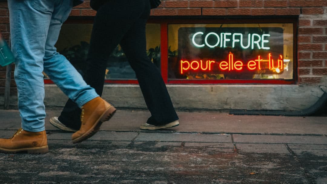 A couple of people walking down a street