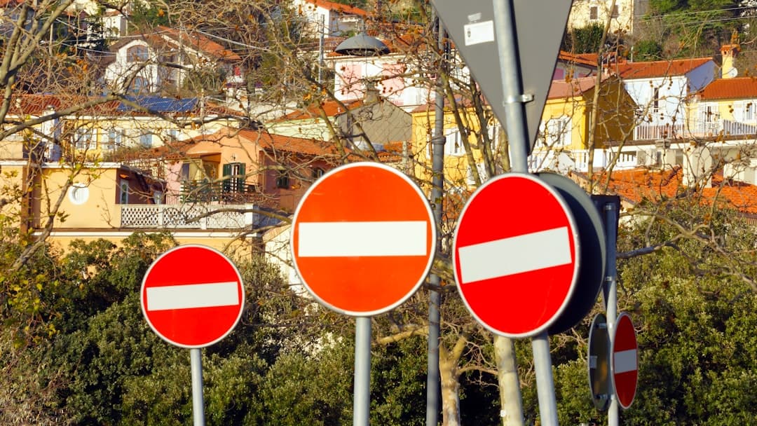 red white and blue round road sign