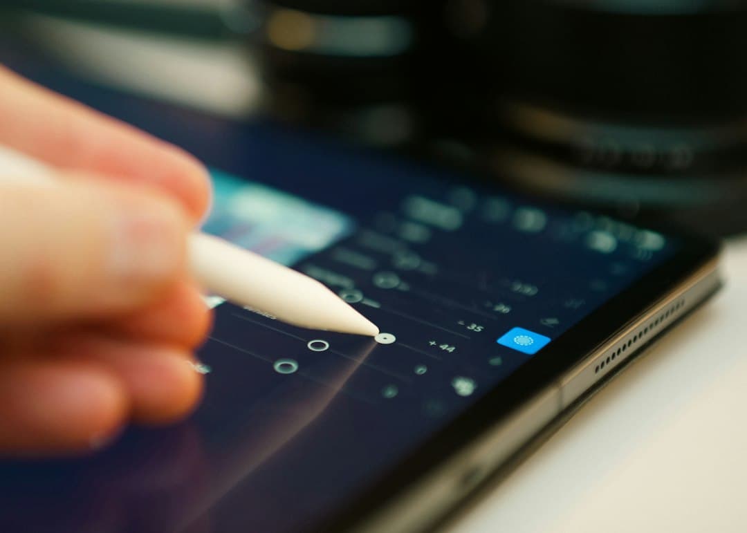 Someone is editing with a stylus on a tablet