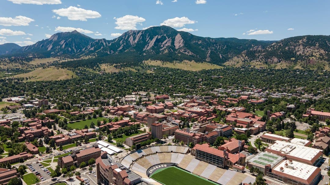 an aerial view of a city with mountains in the background