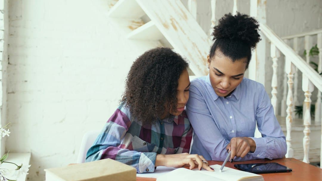 Mother and daughter studying together at a table