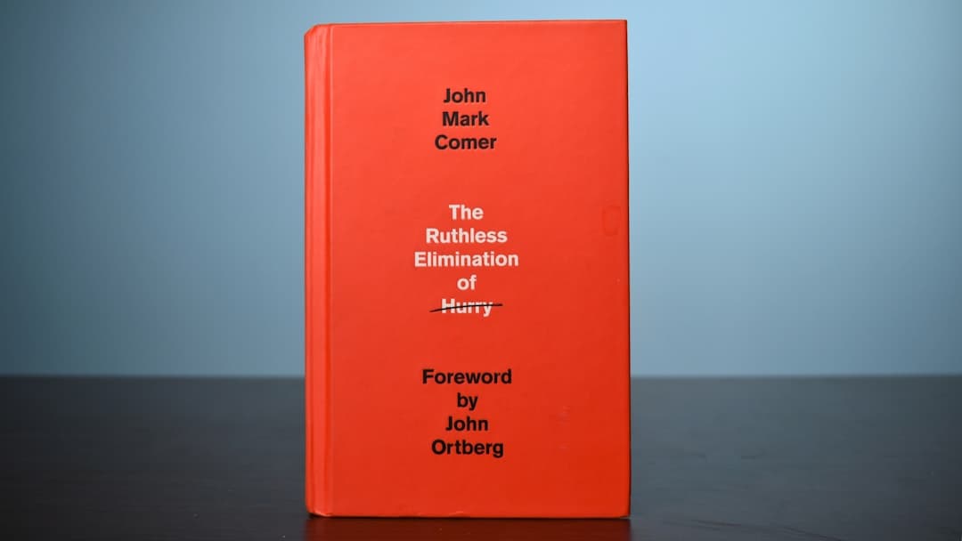 a red book sitting on top of a wooden table