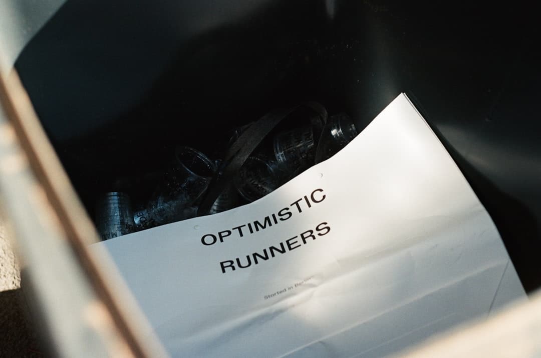 Paper with "optimistic runners" text in a box